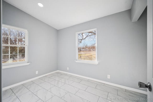 spare room with vaulted ceiling and plenty of natural light