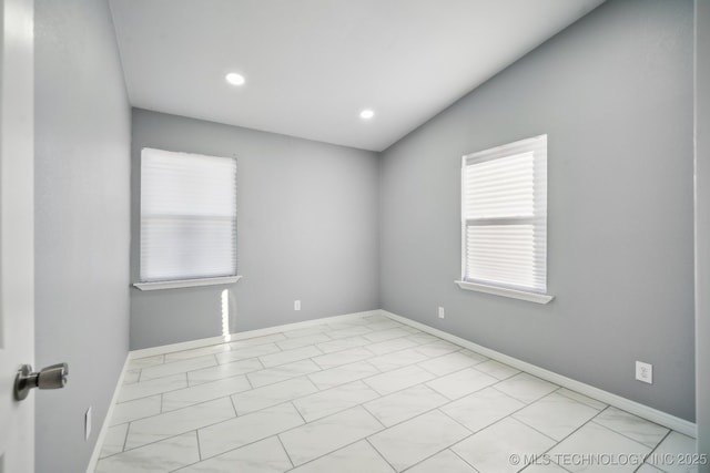 spare room with lofted ceiling and a healthy amount of sunlight