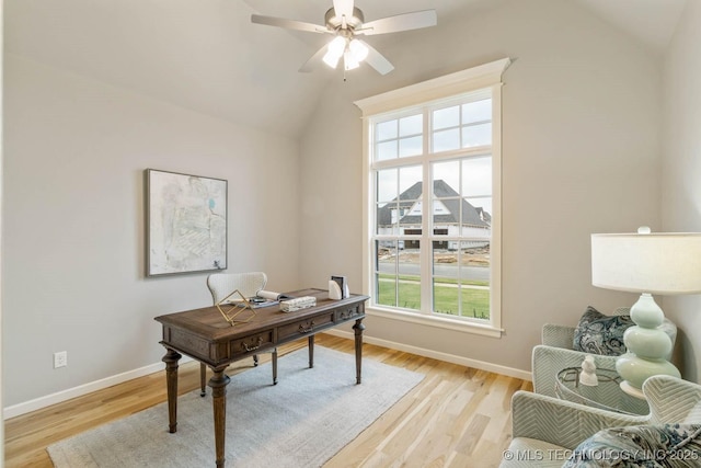 office featuring lofted ceiling, light wood-style flooring, baseboards, and ceiling fan