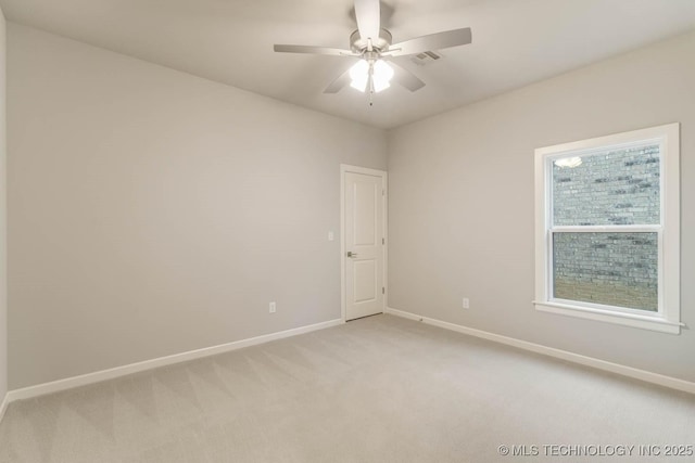 empty room with a ceiling fan, light carpet, visible vents, and baseboards