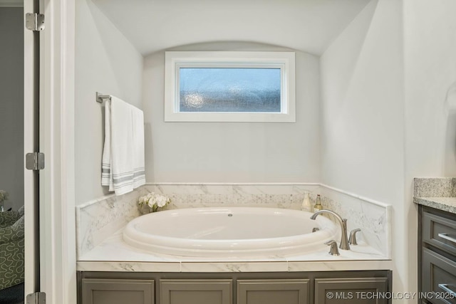 bathroom with a bath and vanity