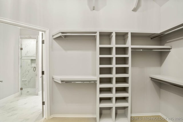 spacious closet featuring marble finish floor