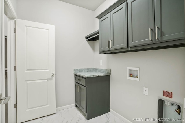 clothes washing area featuring cabinet space, baseboards, hookup for a washing machine, and marble finish floor