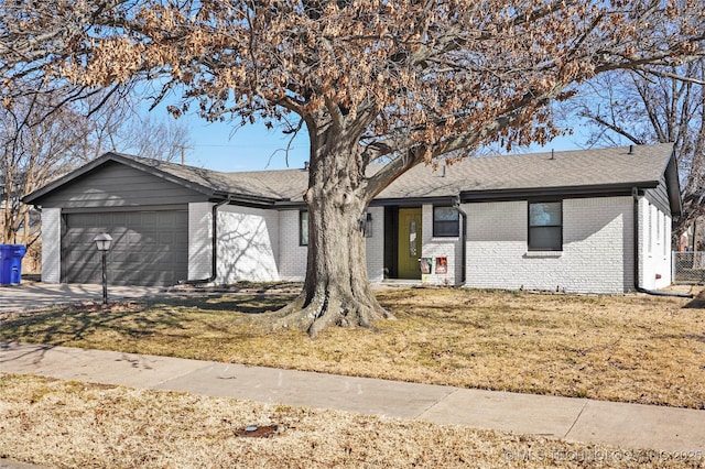 single story home with a garage and a front lawn