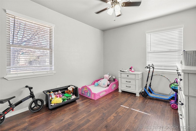 playroom featuring dark wood-type flooring and ceiling fan