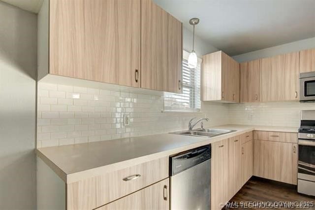 kitchen featuring sink, decorative backsplash, hanging light fixtures, stainless steel appliances, and light brown cabinets