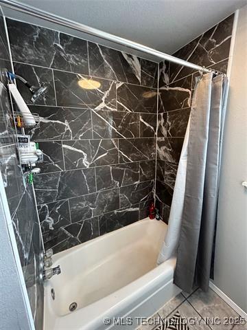 bathroom with shower / tub combo and tile patterned floors