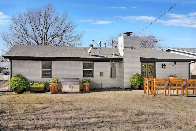 rear view of house featuring a yard