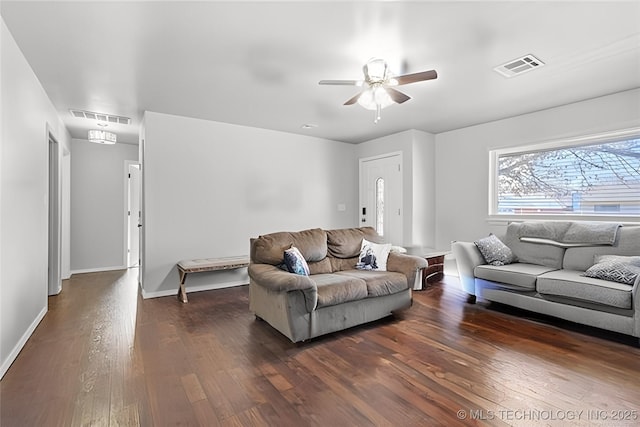 living room featuring ceiling fan and dark hardwood / wood-style flooring