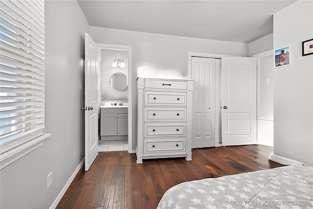 bedroom with dark hardwood / wood-style floors and a closet