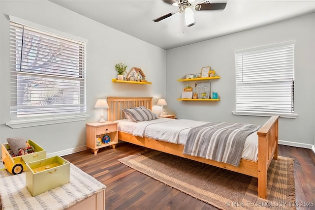 bedroom with dark hardwood / wood-style floors and ceiling fan