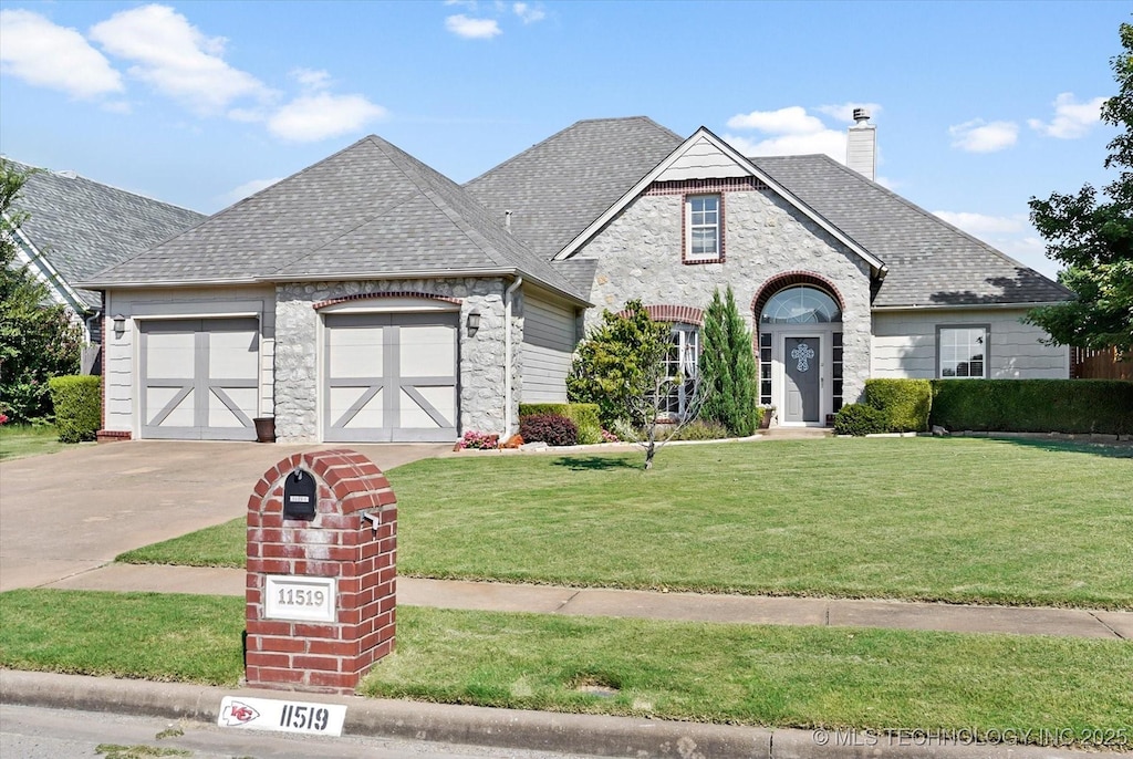 french country home with a garage and a front lawn