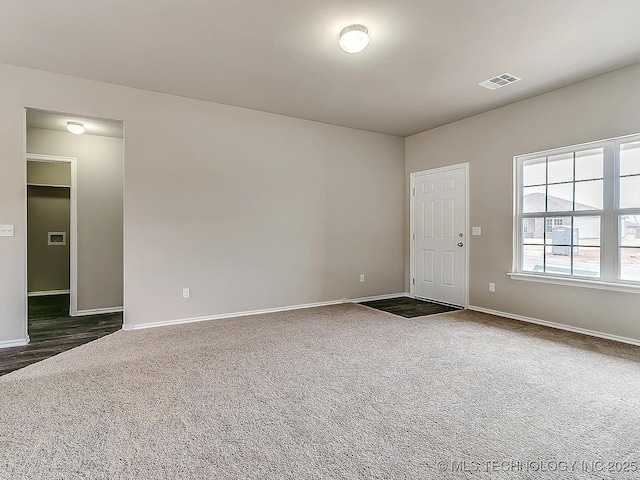 empty room with dark colored carpet