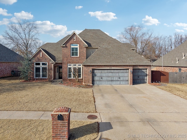 front facade featuring a garage and a front lawn