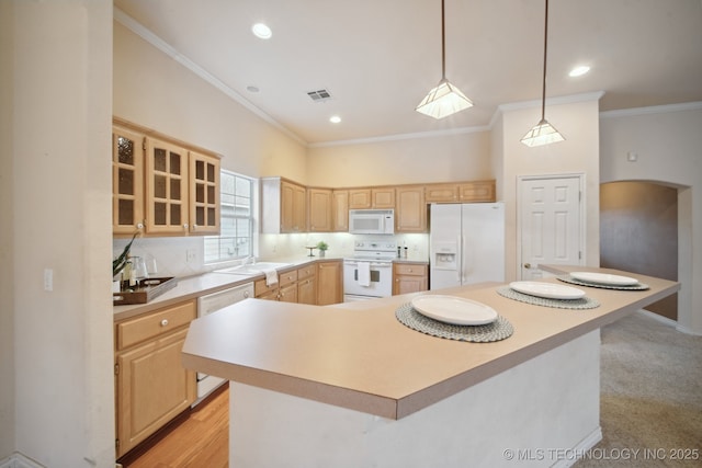 kitchen featuring tasteful backsplash, white appliances, light brown cabinets, and a kitchen island