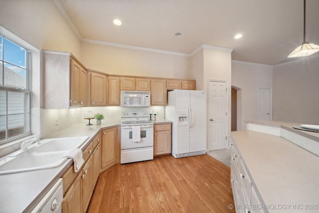 kitchen featuring sink, light brown cabinets, pendant lighting, white appliances, and light hardwood / wood-style floors