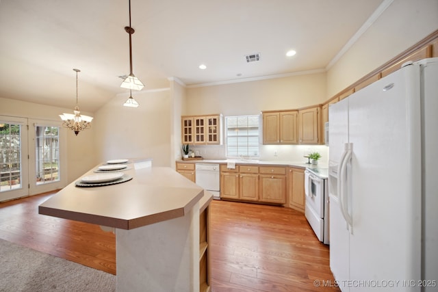 kitchen with light brown cabinetry, decorative light fixtures, a center island, white appliances, and light hardwood / wood-style floors