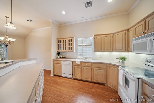 kitchen featuring white appliances, plenty of natural light, decorative light fixtures, and sink