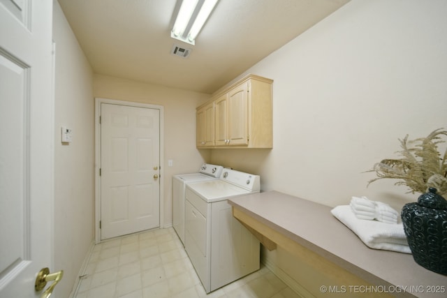 washroom featuring cabinets and washer and dryer