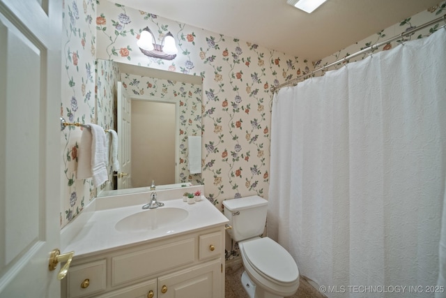 bathroom with vanity, curtained shower, and toilet