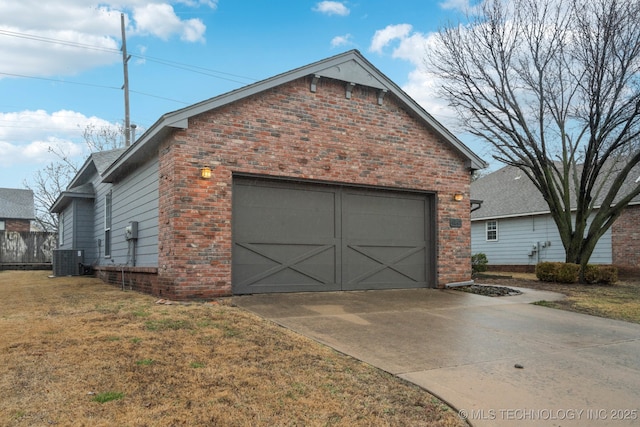 view of front of property featuring central AC, a garage, and a front yard