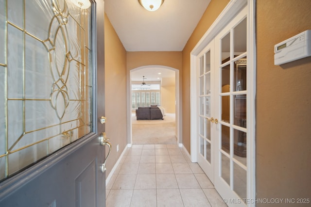 entryway featuring light tile patterned floors and french doors