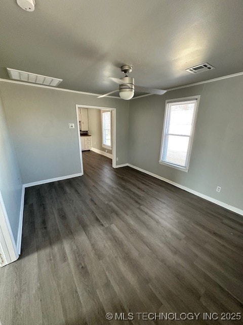 unfurnished room featuring crown molding, ceiling fan, and dark hardwood / wood-style floors