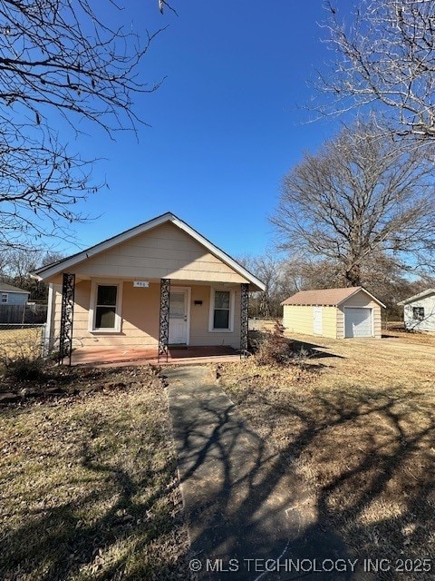 view of front of house with a garage, an outdoor structure, and covered porch