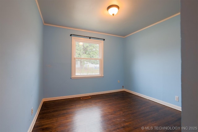 spare room featuring crown molding and dark wood-type flooring