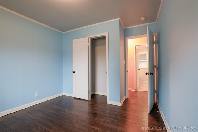 unfurnished bedroom with dark wood-type flooring and ornamental molding