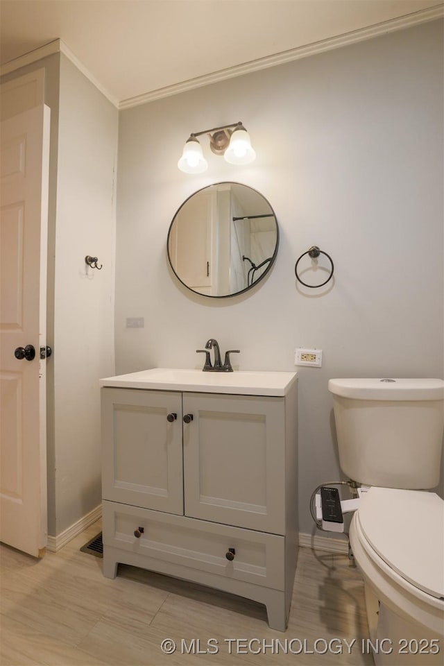 bathroom with vanity, toilet, and hardwood / wood-style floors