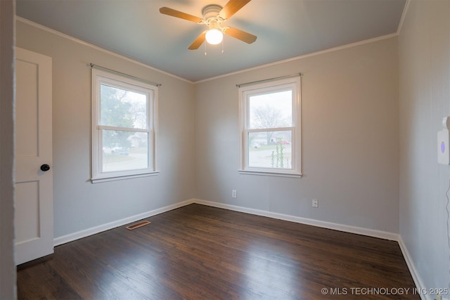 unfurnished room featuring dark wood-type flooring, plenty of natural light, and ornamental molding