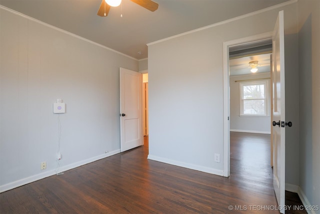 spare room featuring dark hardwood / wood-style flooring, crown molding, and ceiling fan