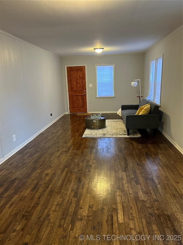 foyer entrance featuring ornamental molding and dark hardwood / wood-style flooring