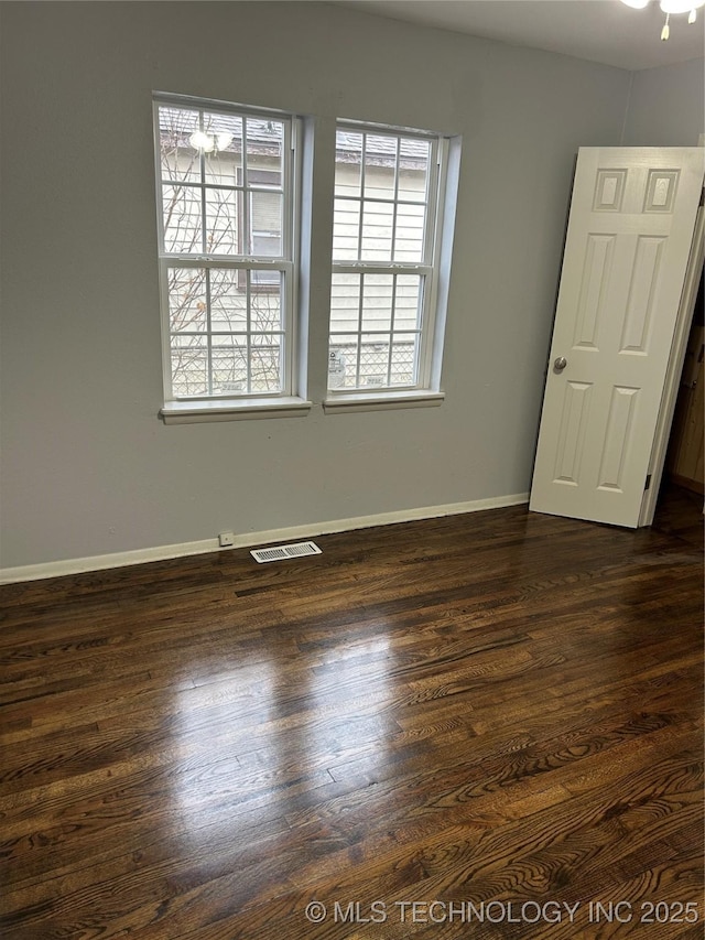 unfurnished room featuring dark hardwood / wood-style flooring