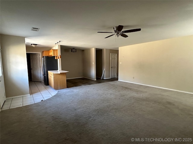 unfurnished living room with light colored carpet and ceiling fan