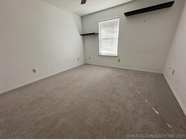 empty room featuring carpet floors and ceiling fan