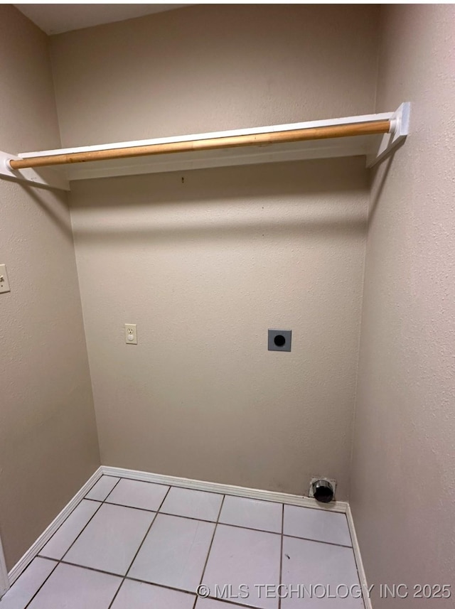 310 Northridge, Durant, OK 74701 - laundry area featuring light tile patterned flooring, hookup for an electric dryer, and baseboards