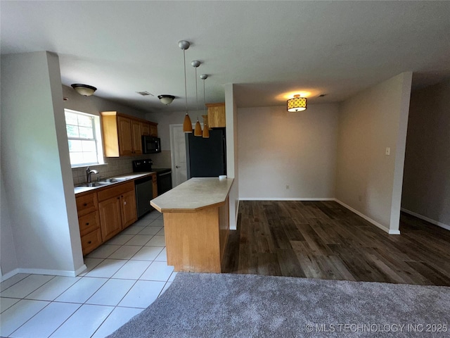 310 Northridge, Durant, OK 74701 - kitchen featuring black appliances, a sink, light countertops, and baseboards