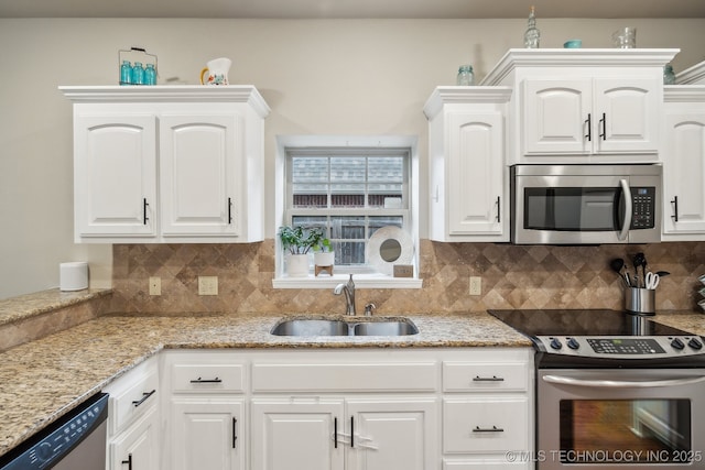 kitchen featuring stainless steel appliances, light stone countertops, sink, and white cabinets