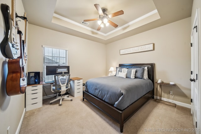 bedroom with crown molding, a raised ceiling, and light carpet