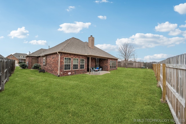 back of house with a patio and a lawn