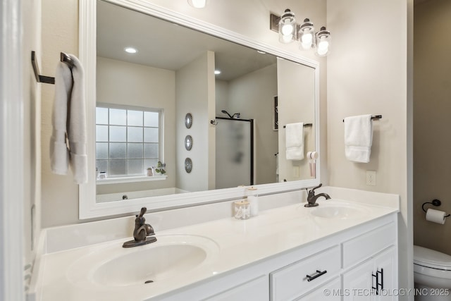 bathroom featuring an enclosed shower, vanity, and toilet