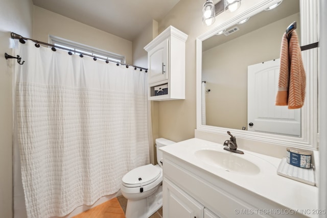 bathroom featuring vanity and toilet