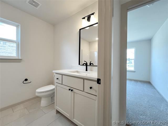 bathroom with vanity and toilet