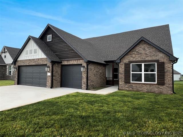 view of front of house with an attached garage, brick siding, a shingled roof, driveway, and a front lawn