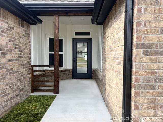 doorway to property with brick siding