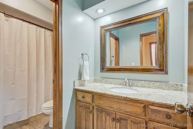 bathroom with vanity, toilet, and tile patterned flooring