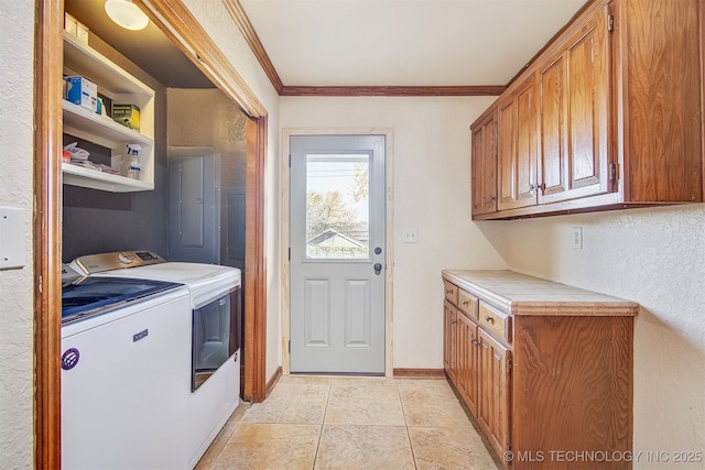 laundry room featuring cabinets, light tile patterned floors, washing machine and clothes dryer, electric panel, and crown molding