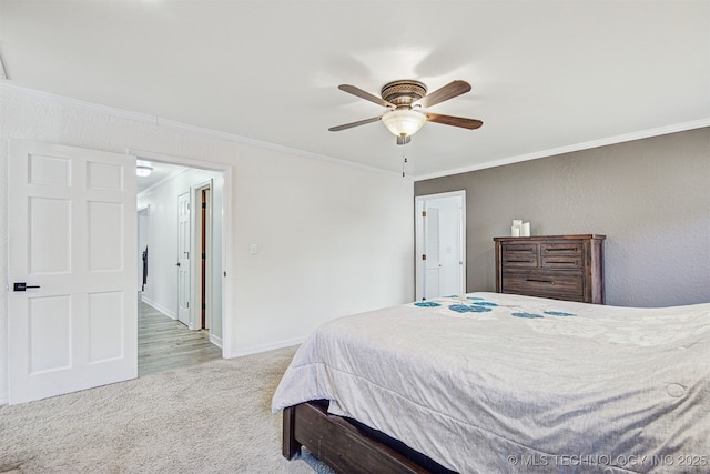 carpeted bedroom featuring ornamental molding and ceiling fan